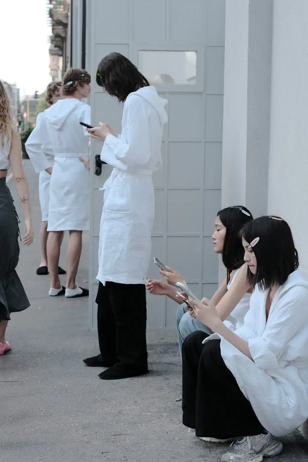 Models resting in JW Anderson show